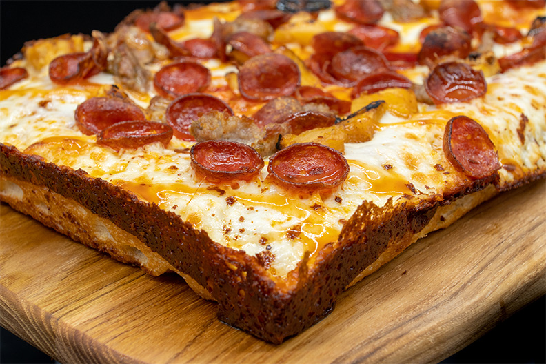 Close up of Detroit style pizza made at our Barclay-Kingston, Cherry Hill food place.