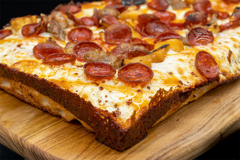 Close up of Detroit style pizza made at our Barrington food place.